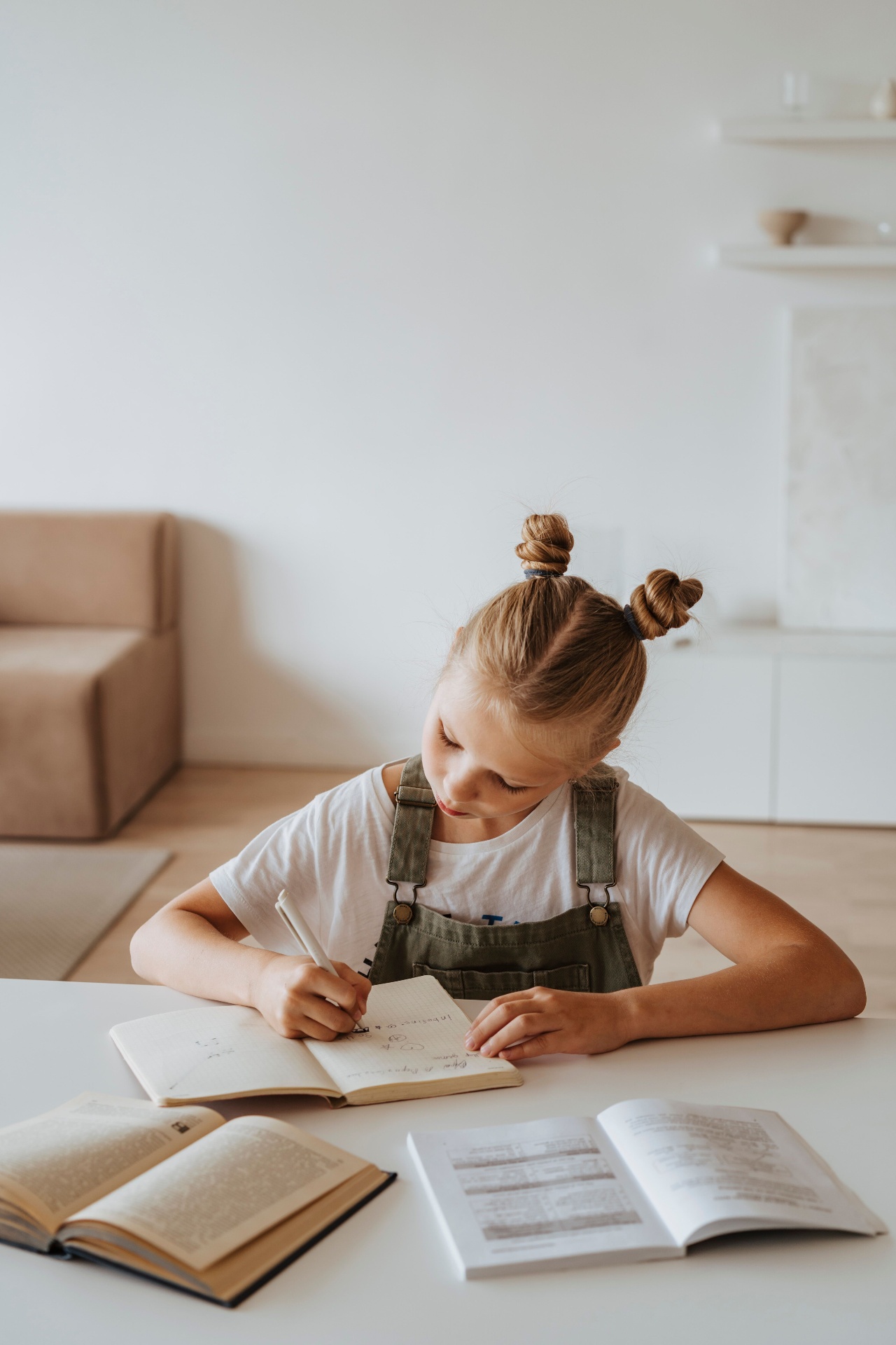 Young student writing in a notebook during a focused learning session
